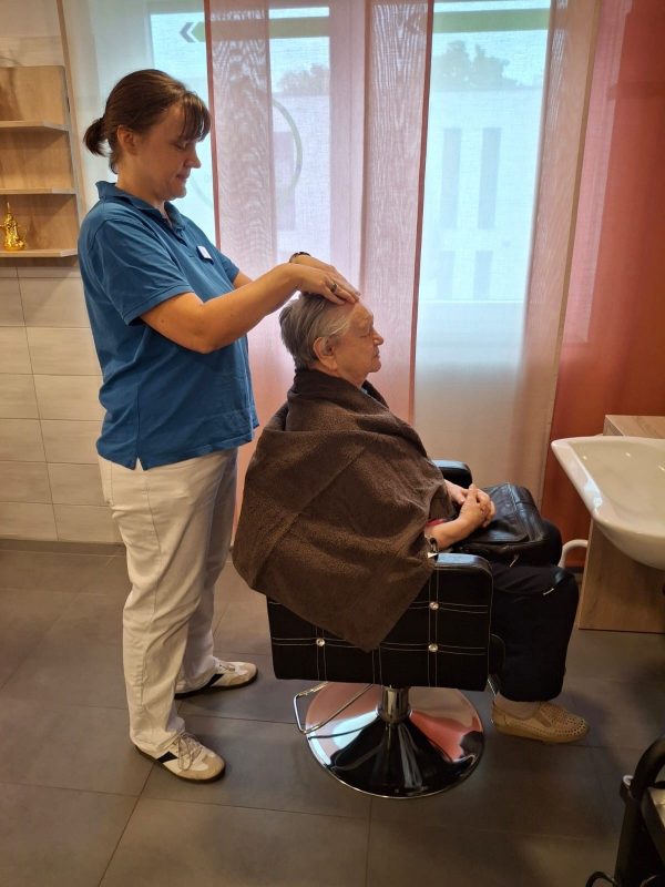 Seniorin entspannt bei einer Kopfmassage in der Seniorenbetreuung Leipzig-Stötteritz.